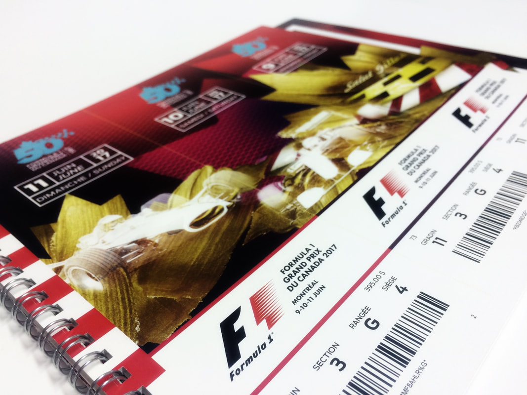 Close-up of a wire-bound reserved-seat ticket book printed by D.English, showing full-colour event artwork, seat and section data, and barcodes