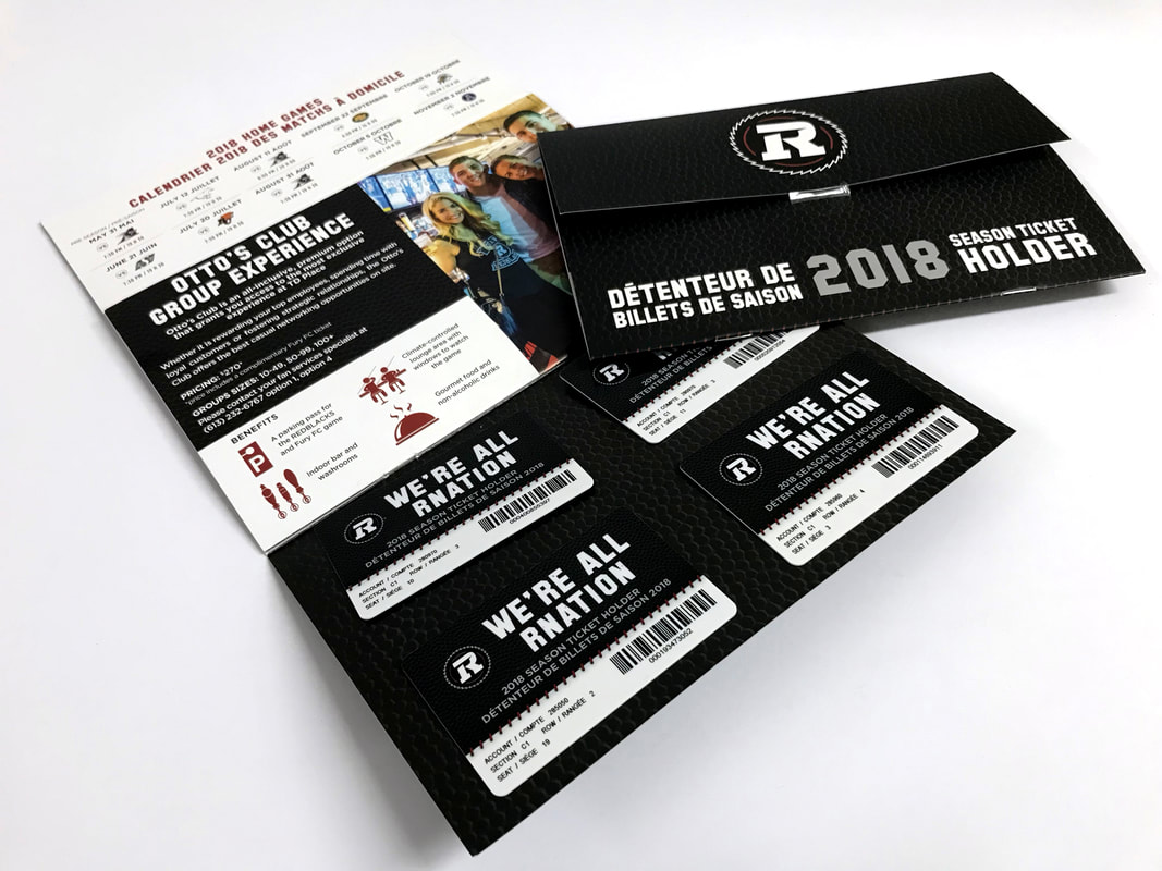 Sheets of printed reserved-seat tickets showing section, row, and seat data with perforated stubs